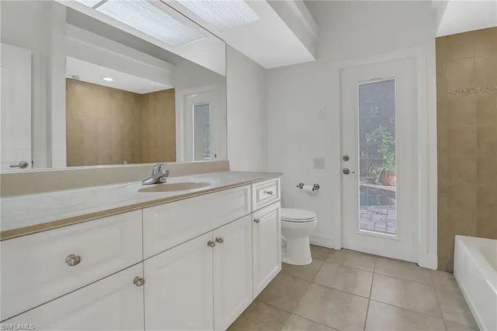 Bathroom featuring tile patterned floors, toilet, and vanity