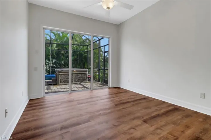 Unfurnished room with ceiling fan and dark hardwood / wood-style floors