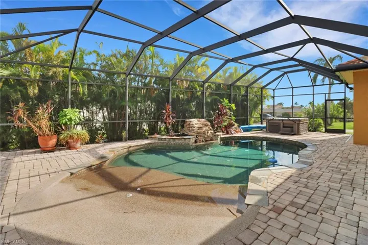 View of pool with a patio, a jacuzzi, and a lanai
