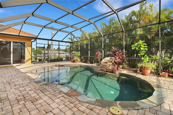 View of swimming pool with a patio area and a lanai