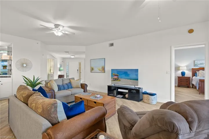 Living room with light hardwood / wood-style flooring and ceiling fan