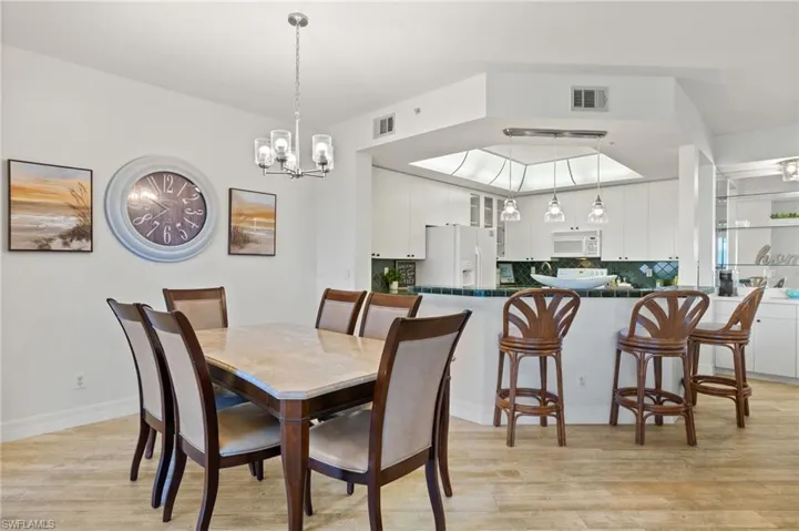 Dining area featuring a notable chandelier and light hardwood / wood-style flooring