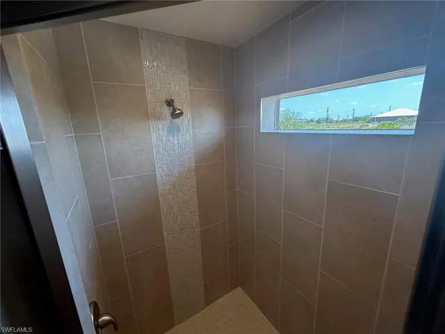 Bathroom featuring tiled shower