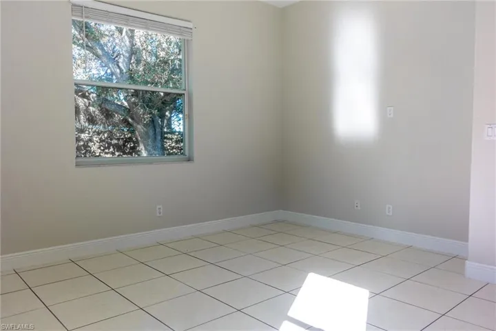 Spare room with baseboards and light tile patterned floors