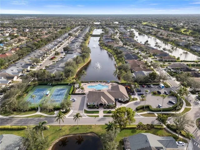 Aerial view of property's location featuring a large body of water and nearby suburban area