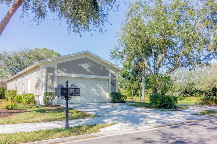View of home's exterior featuring driveway, stucco siding, and an attached garage