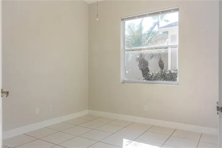Unfurnished room featuring baseboards and light tile patterned floors