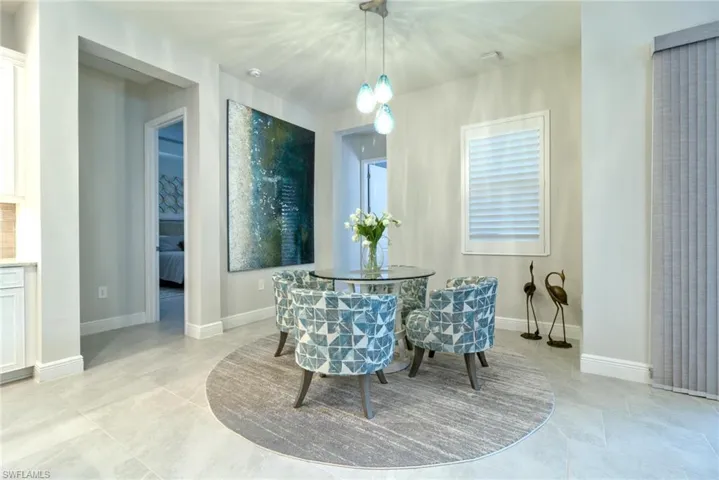 Large Kitchen nook with plantation shutter window with view of outdoor lanai kitchen