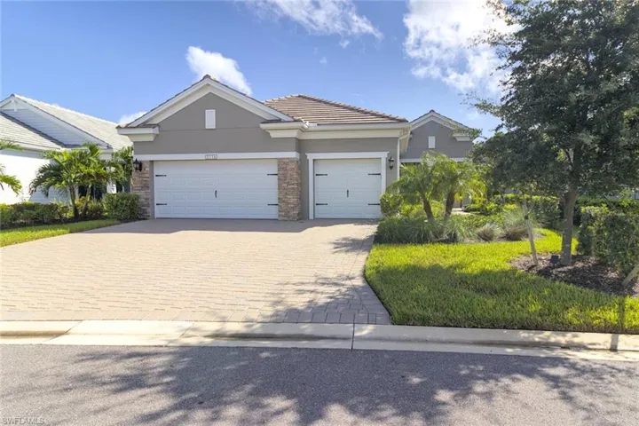 3116 Preserves Edge Ct featuring a Three garage and paver driveway