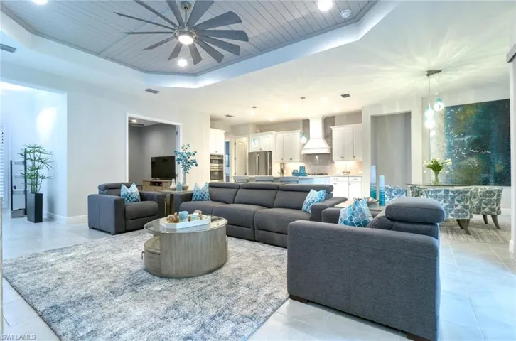 Spacious great room featuring Shiplap trey ceiling and tile flooring