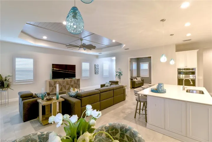 Living room featuring a healthy amount of sunlight with plantation shutters on all the windows