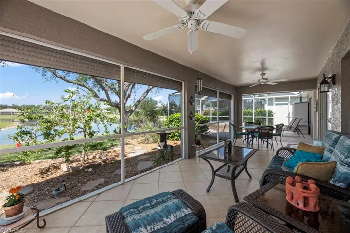 Huge Covered Lakefront Lanai with Electric Shutters, Tile Flooring, Full Bath Access Door, 2 Ceiling Fans and Extended Screened Area to Spa