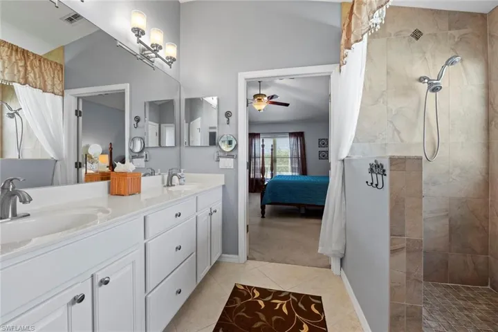 Dual Sinks and Vanities with additional Center Drawers, Walk-in Tiled shower