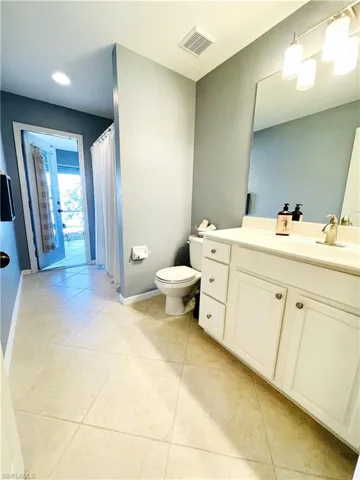 Full Bath from interior hall with 2 bedrooms with direct Access to covered lanai & spa area
