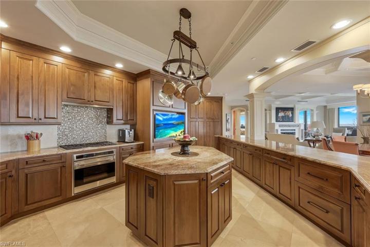 Gas cooktop, a built in television and a center island - the perfect ingredients for participating in an online cooking class!