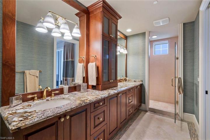 Ensuite guest bathroom with double sinks and plenty of storage space.