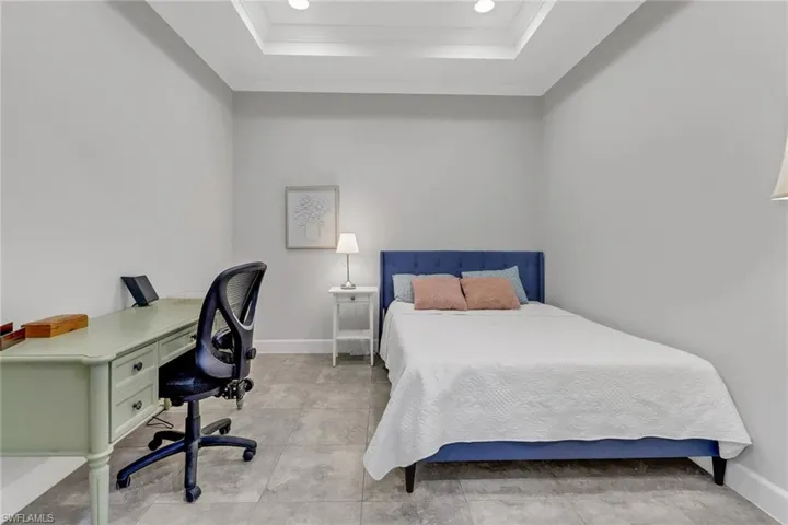 Bedroom featuring crown molding and a tray ceiling