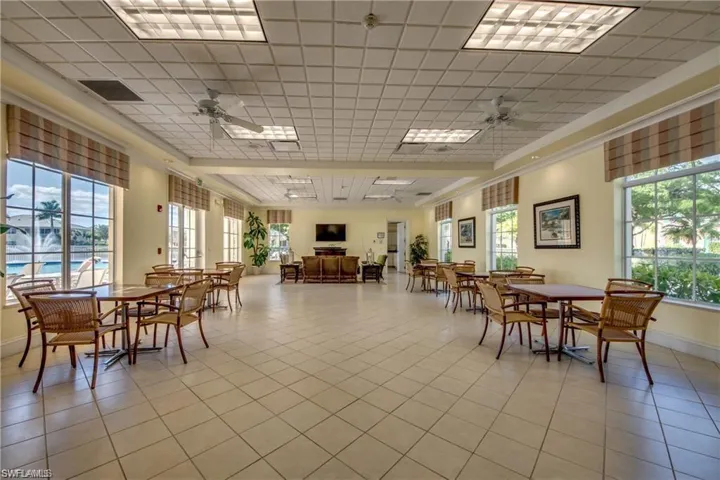 Dining space with a wealth of natural light, ceiling fan, and light tile patterned flooring