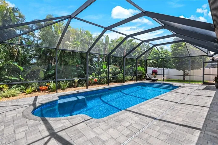 Gorgeous back lanai with brick paved pool lanai and fenced in yard.