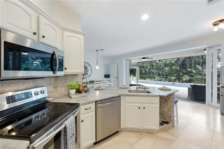 Updated kitchen with stainless steel appliances, quartz counters and coffee bar.