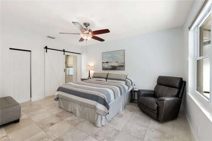 Master suite with barn door entry to master bath