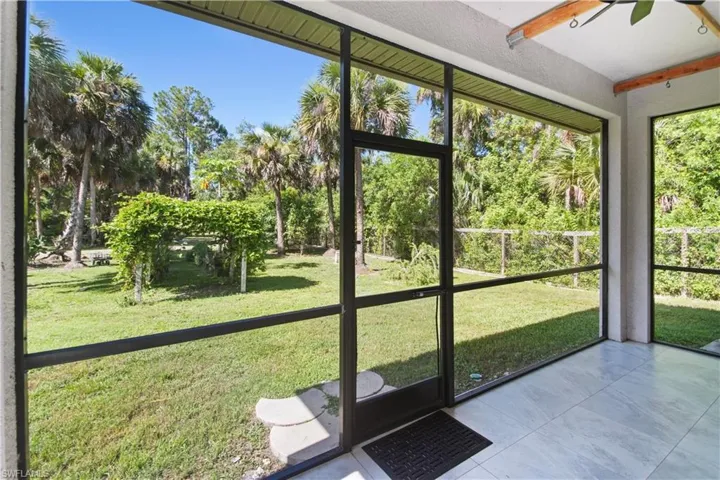 Unfurnished sunroom with ceiling fan