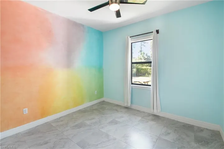Unfurnished room featuring ceiling fan and tile flooring