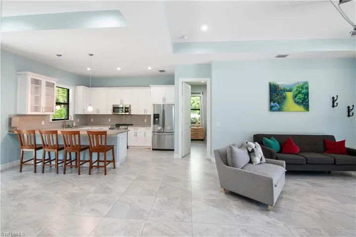 Tiled living room featuring sink