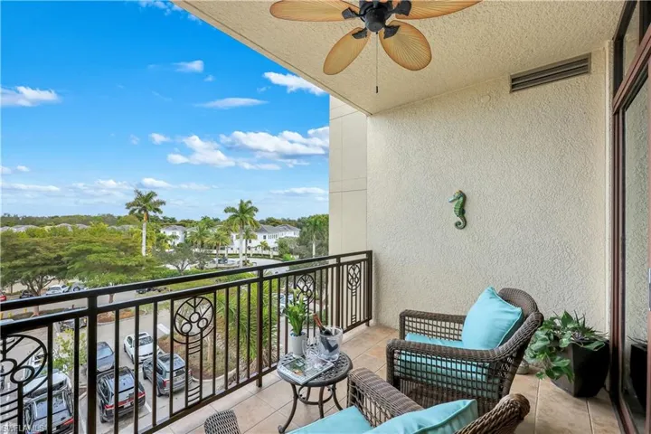 Balcony featuring a sunroom and a ceiling fan