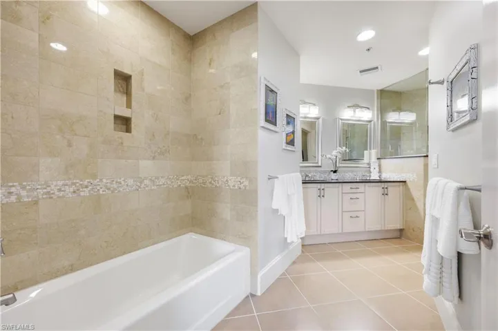 Full bathroom featuring light tile patterned flooring, vanity, shower / bath combination, and recessed lighting