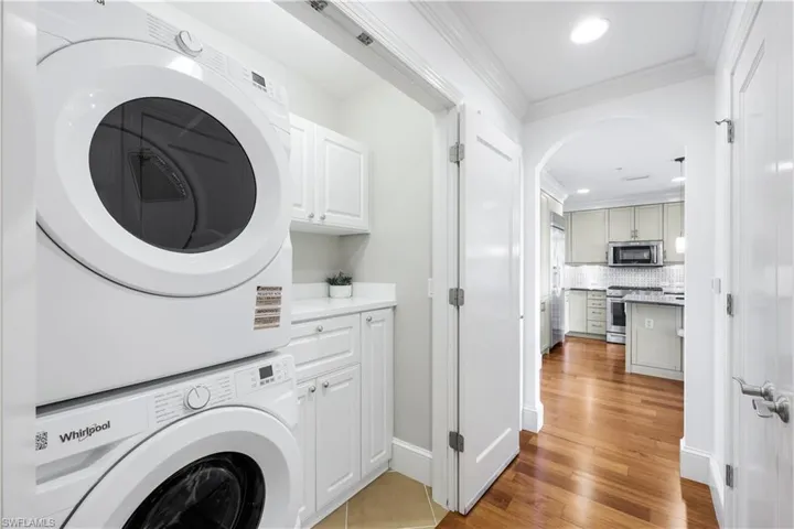 Laundry area w/ built-in cabinet space, and New  washing machine and dryer