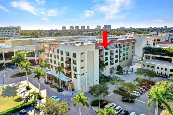 View of building exterior with a view of skyline and uncovered parking