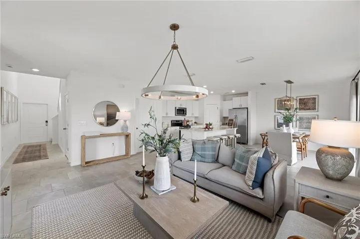 Living room featuring recessed lighting and a chandelier