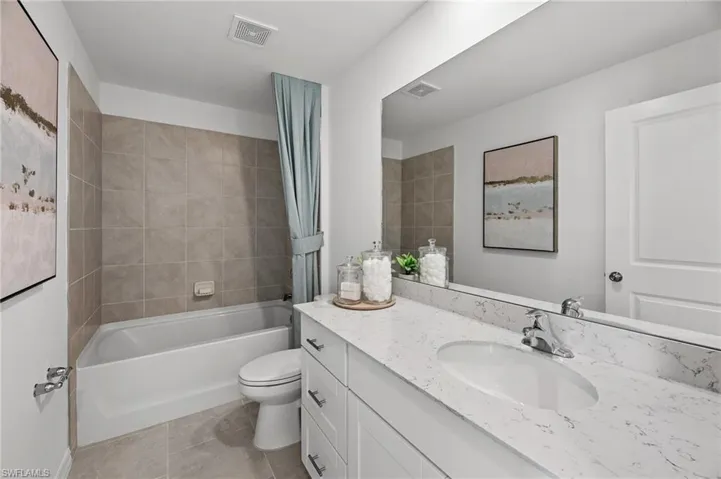 Full bathroom with vanity, tile patterned flooring, and shower / tub combination