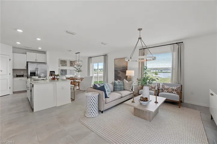 Living room with a chandelier, recessed lighting, and light tile patterned flooring
