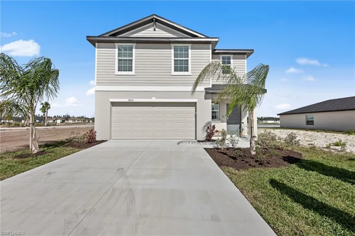 View of front of house with concrete driveway, an attached garage, and stucco siding