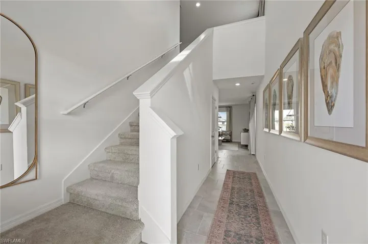 Stairway with recessed lighting and baseboards