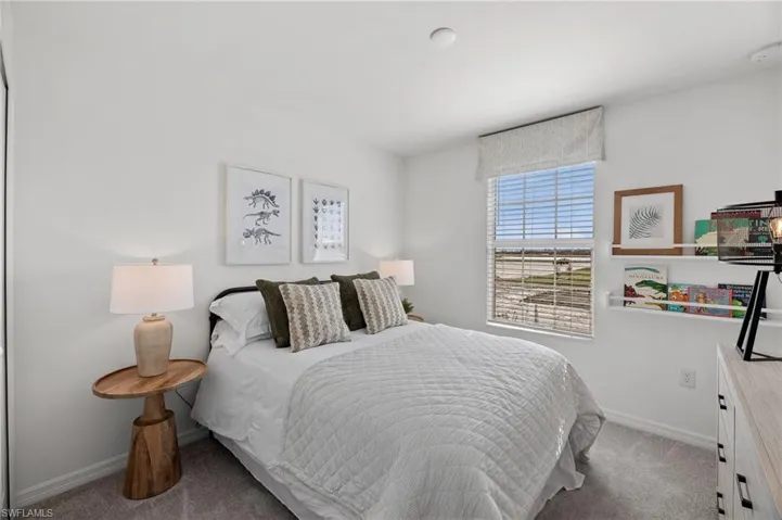 Carpeted bedroom with baseboards