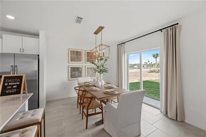 Dining room with a chandelier and light tile patterned floors