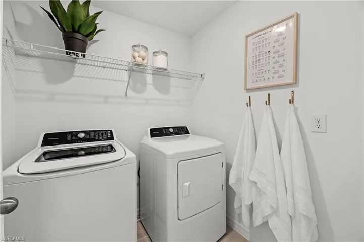 Washroom featuring washing machine and dryer