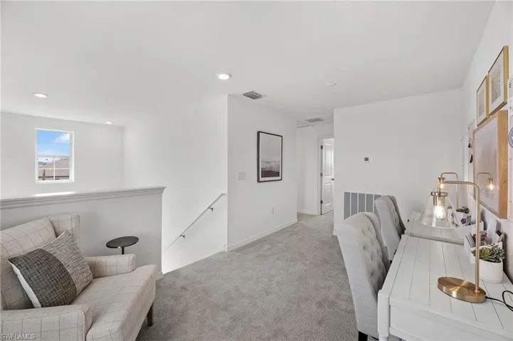 Office space featuring light carpet and recessed lighting