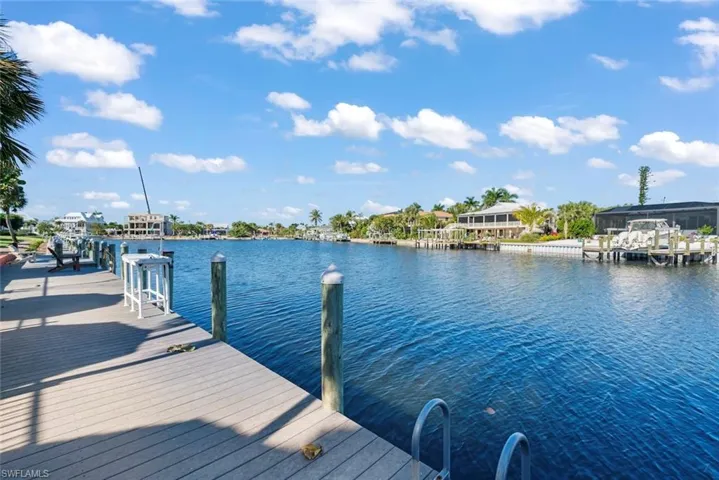 Waterfront property featuring a private dock with marine pilings and ladder access to the water