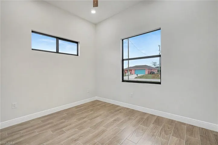 Unfurnished room with wood finish floors, recessed lighting, and a ceiling fan