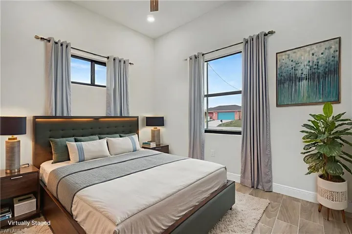 Bedroom with wood finish floors, a ceiling fan, and recessed lighting