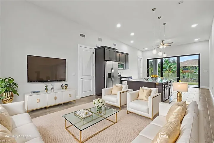 Living room with ceiling fan, recessed lighting, and light wood finished floors