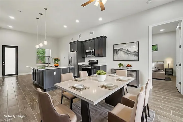 Dining room with wood finish floors, recessed lighting, and a ceiling fan