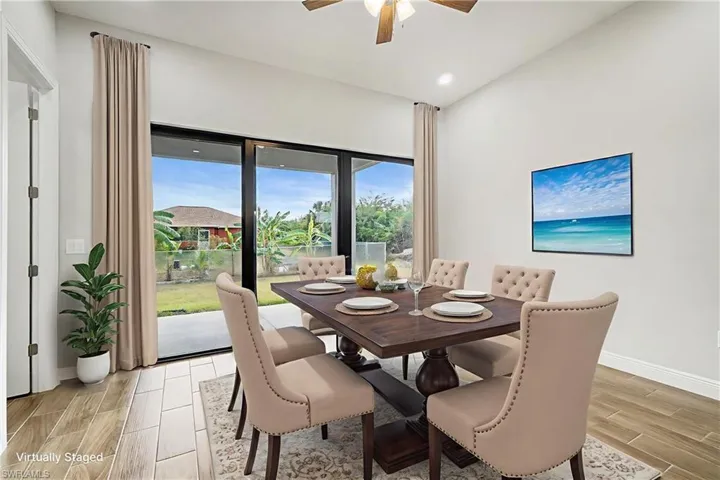 Dining space with wood finish floors, ceiling fan, and recessed lighting