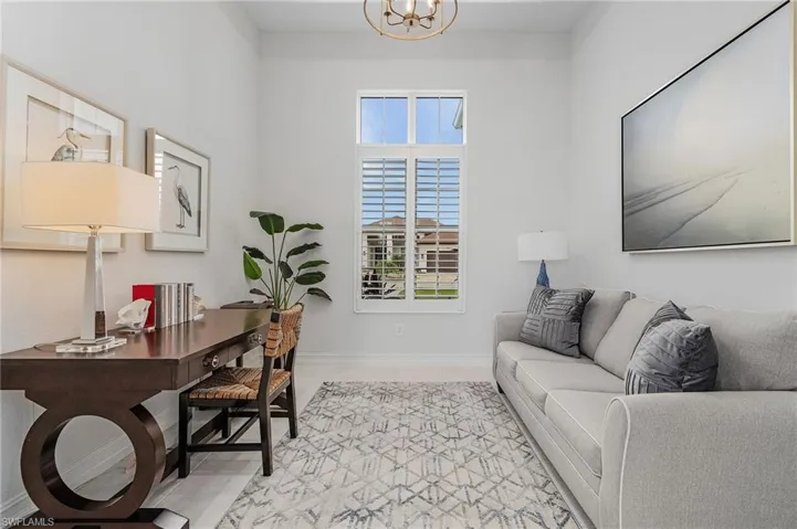 Office area featuring light tile patterned floors and a chandelier