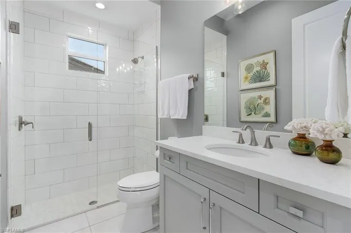 Bathroom featuring vanity, a stall shower, and tile patterned floors