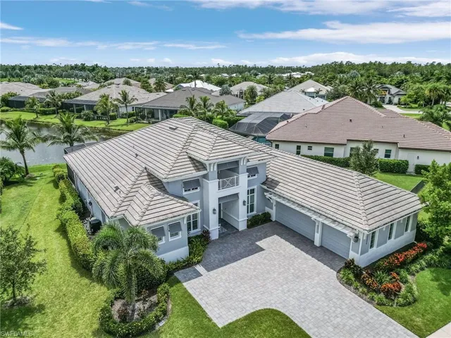 Aerial perspective of suburban area featuring a large body of water